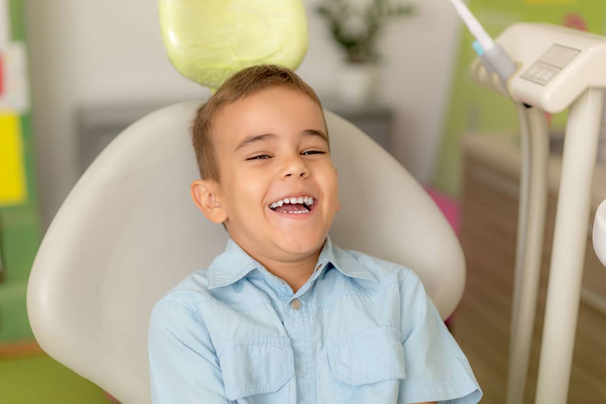 Child in dentist chair smiling image